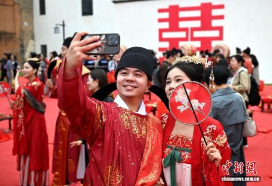 图为新人在仪式结束后自拍。中新社记者 吕明 摄 图为新人在仪式结束后自拍。中新社记者 吕明 摄