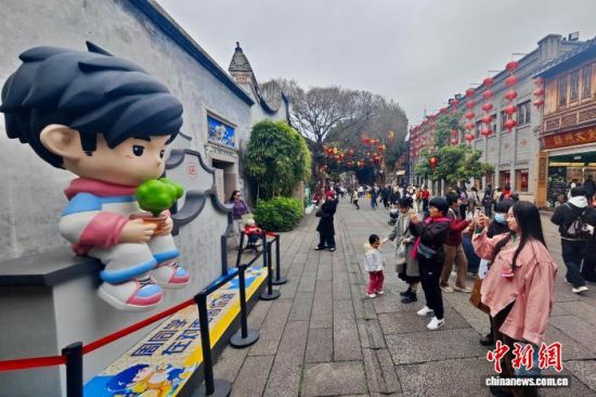 1月24日,福建福州,游客在南后街周杰伦人偶处打卡。中新社记者 王东明 摄 1月24日,福建福州,游客在南后街周杰伦人偶处打卡。中新社记者 王东明 摄